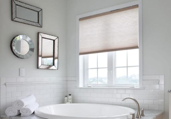 Lutron cellular honeycomb shades in a bright bathroom