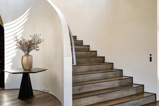 Josh Nano on a wall beside a staircase